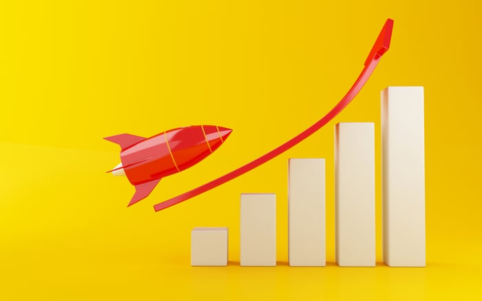 A red rocket prepares to fly over a rising bar chart.