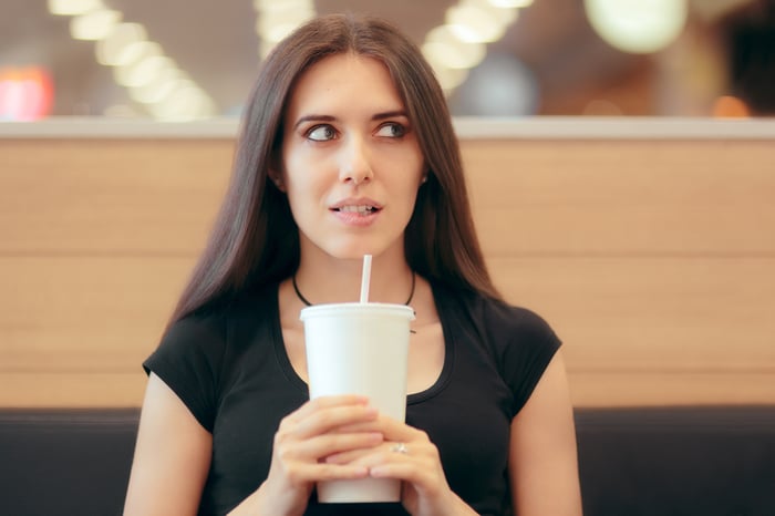 Person holding a drink.